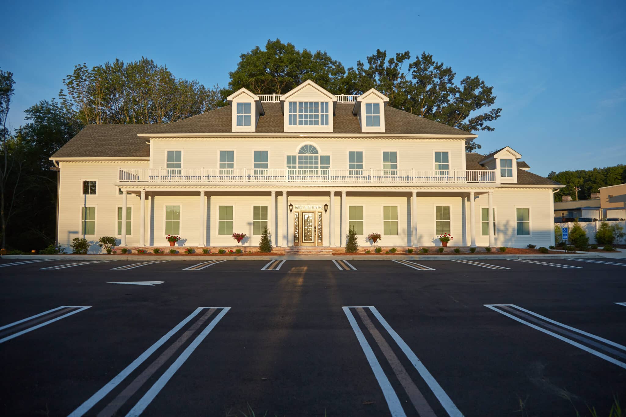 Front of the Orange office building with covered porch, central entrance, and parking area